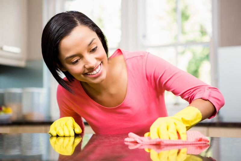 woman in gloves cleaning the table