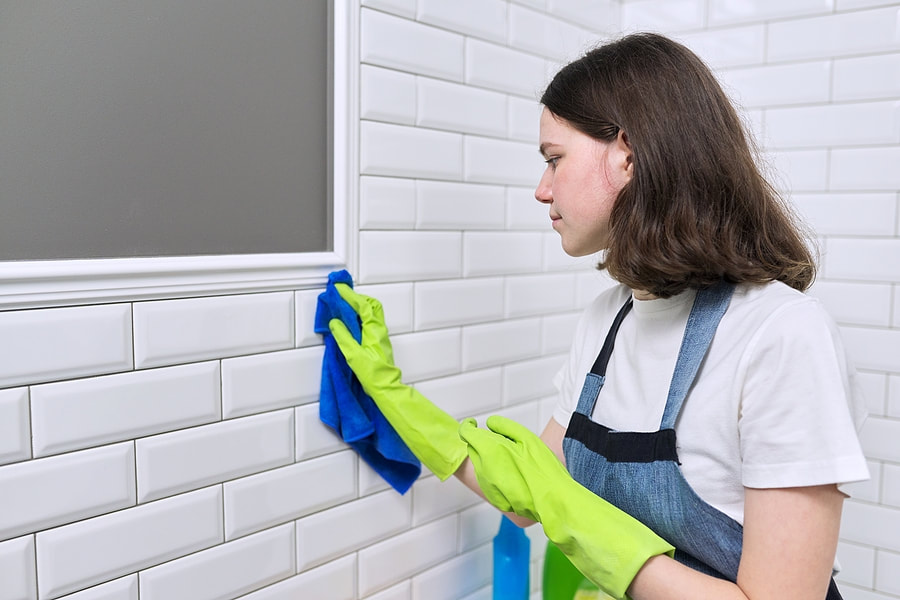 woman cleaning the walls