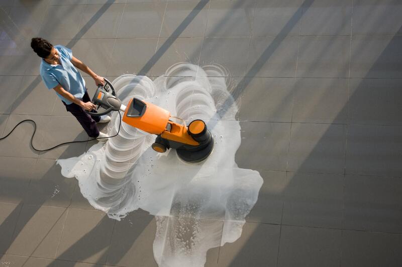 worker using a floor polisher